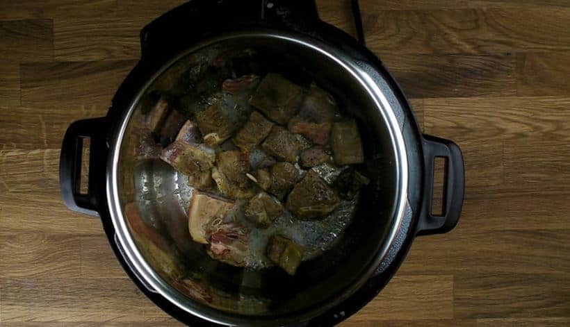 Pressure Cooker Curry Goat Recipe (Instant Pot Goat Curry): brown goat shoulder in Instant Pot Electric Pressure Cooker