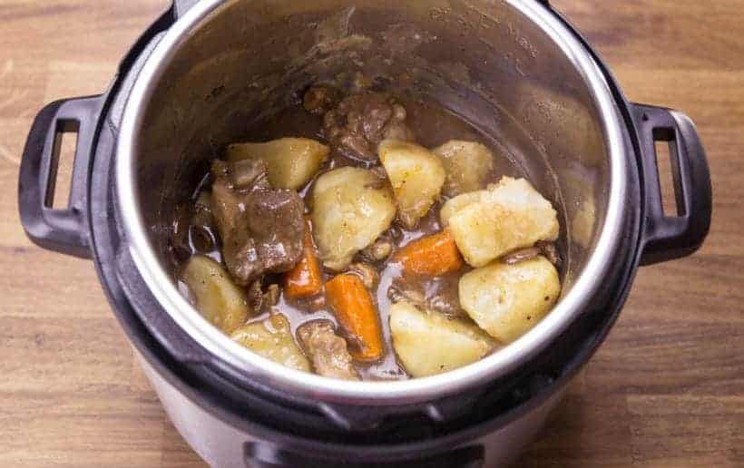 pour pork butt meat, carrots, potatoes back in the gravy in the instant pot pressure cooker