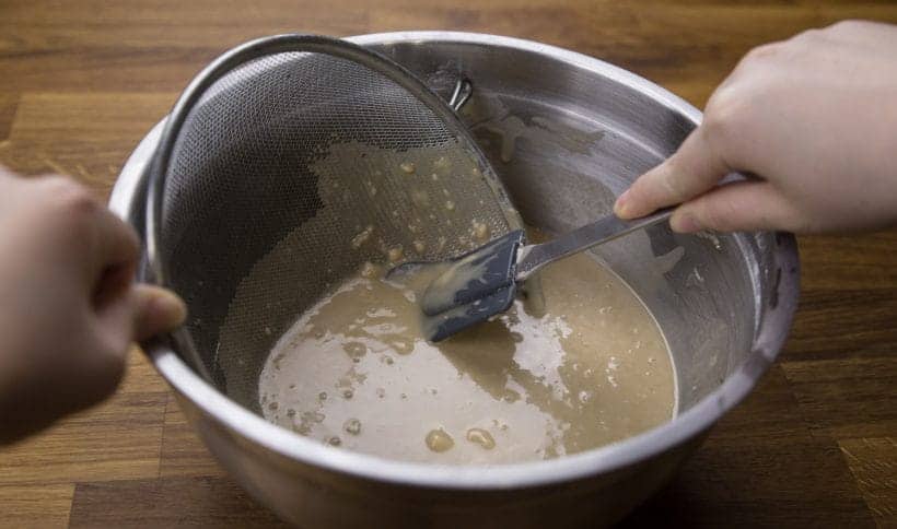 Nian Gao Chinese New Year Cake Recipe: smooth out the lumps in nian gao batter by running the mixture through a fine mesh strainer