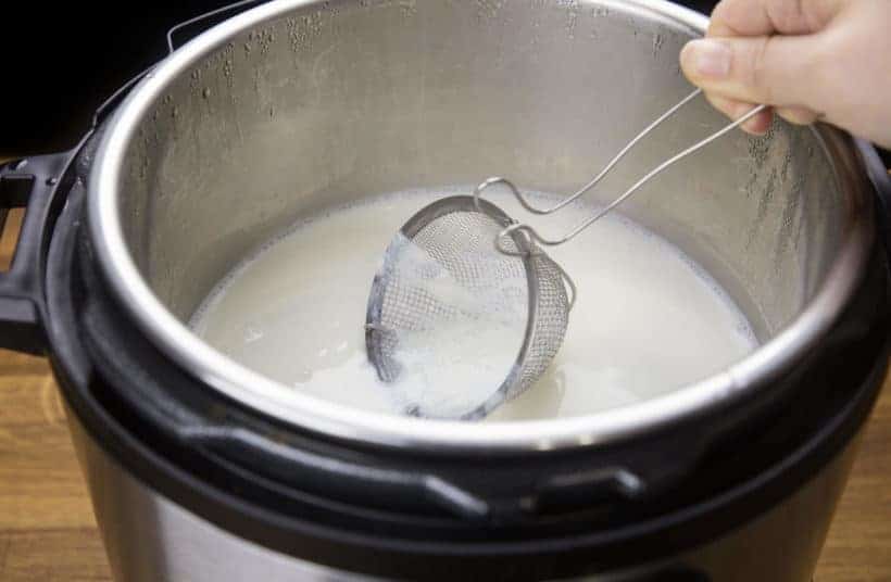 Instant Pot Yogurt Recipe: skim away the heated milk skin