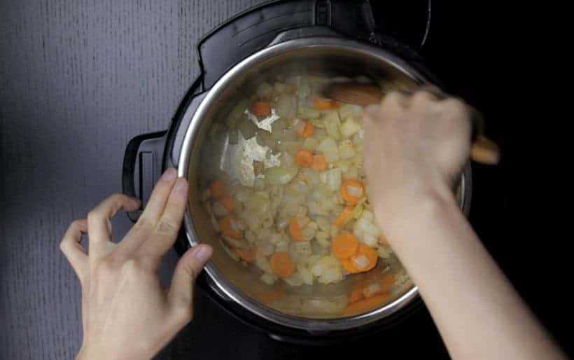 Instant Pot Tomato Soup Recipe (Pressure Cooker Tomato Soup): Saute onions and carrots in Instant Pot Pressure Cooker