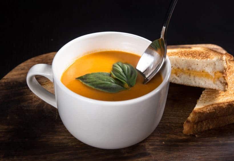 Make this Delicious Creamy Comfort: Instant Pot Tomato Soup Recipe (Pressure Cooker Tomato Soup)! This homemade tomato basil soup from scratch (with vegan option) is healthy, super easy to make, and freezer-friendly. Perfect dip for the toasted golden grilled cheese.