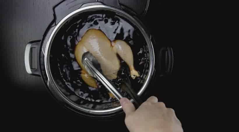 submerge whole chicken in Master Stock with chicken breast side down 