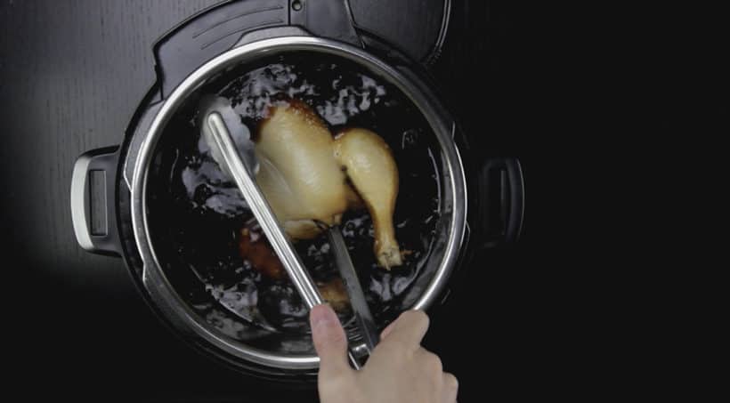 remove whole chicken and drain hot liquid in chicken carcass