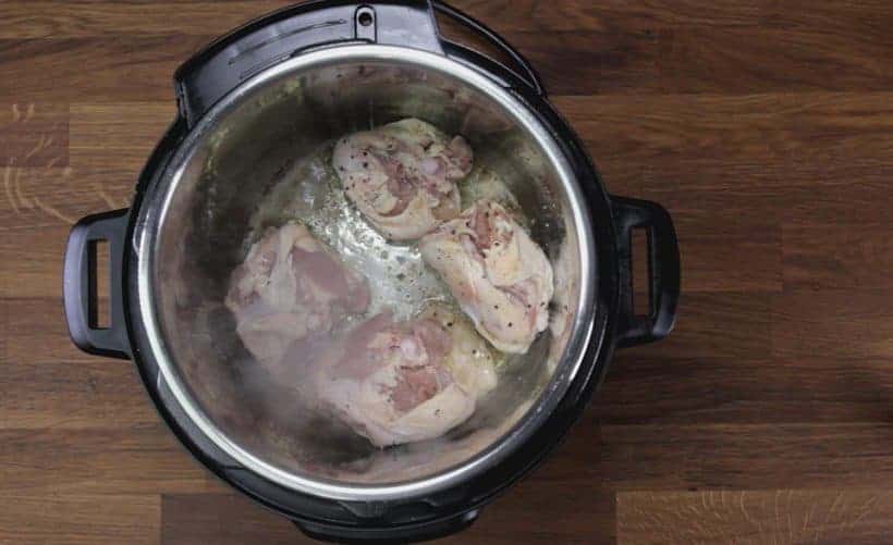 Instant Pot Chicken and Dumplings Recipe (Pressure Cooker Chicken and Dumplings): brown chicken thighs in Instant Pot Electric Pressure Cooker with Saute More function