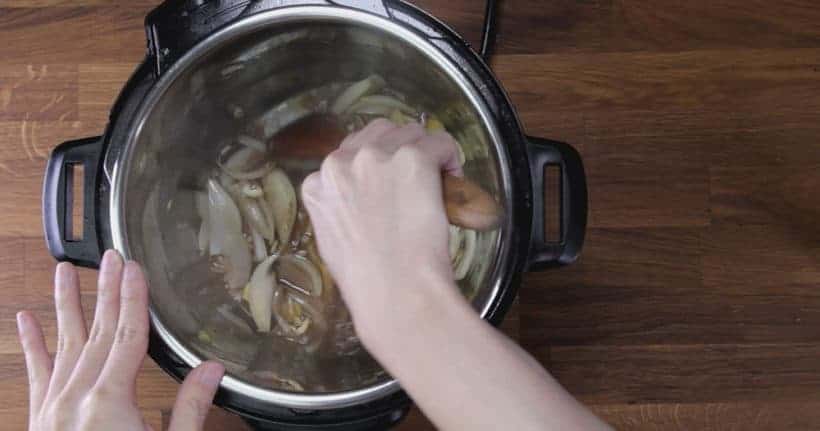 Instant Pot Pork Shoulder: deglaze Instant Pot Pressure Cooker inner pot with wooden spoon