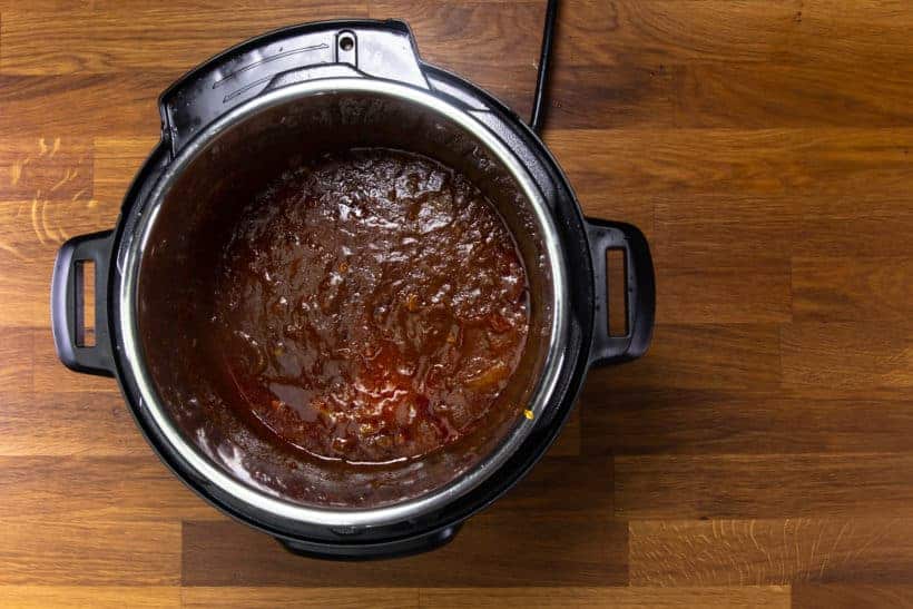 Instant Pot Butter Chicken: stir tomato paste into butter chicken sauce