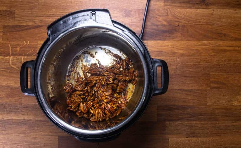 Instant Pot Firecracker Candied Pecans | Glazed Pecans | Spiced Pecans Recipe: stir pecans until maple sriracha sauce darkens in Instant Pot Pressure Cooker