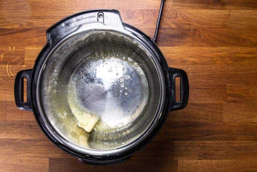Instant Pot Roasted Potatoes: melt unsalted butter in Instant Pot Pressure Cooker