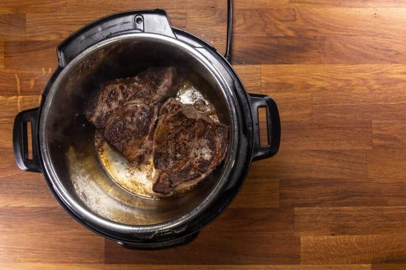 Instant Pot Italian Beef | Pressure Cooker Italian Beef Recipe: season and brown chuck roast in Instant Pot Pressure Cooker for 10 minutes per side