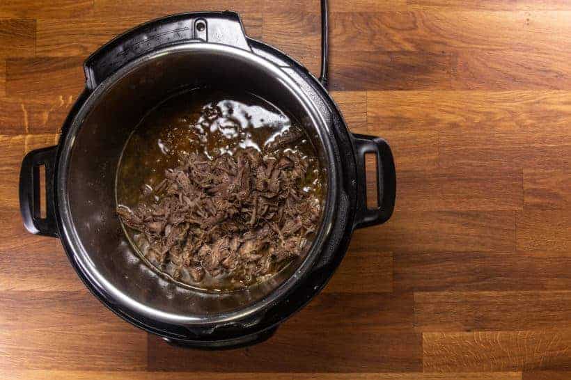 Instant Pot Italian Beef | Pressure Cooker Italian Beef: add shredded beef in Instant Pot Pressure Cooker